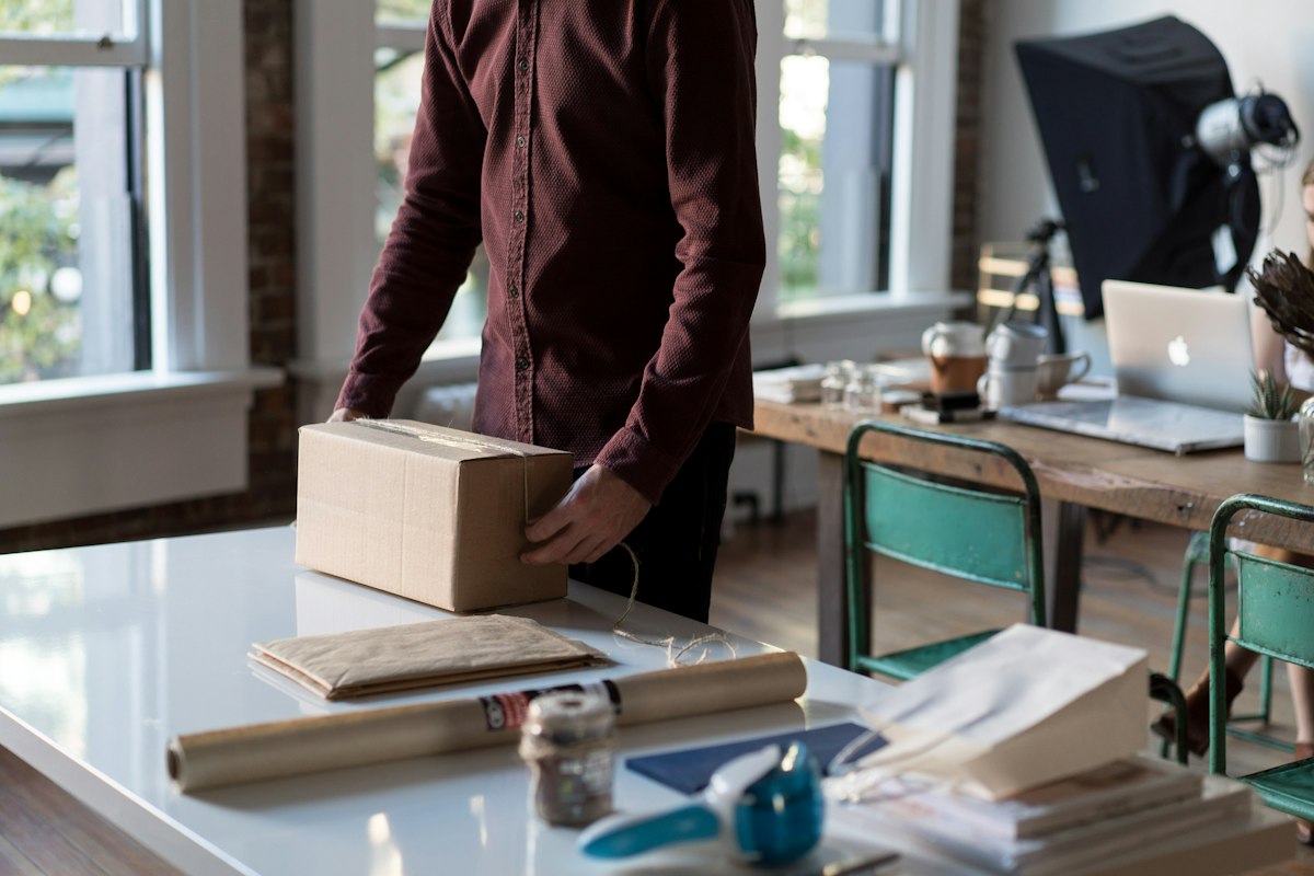 Seller holding a product box