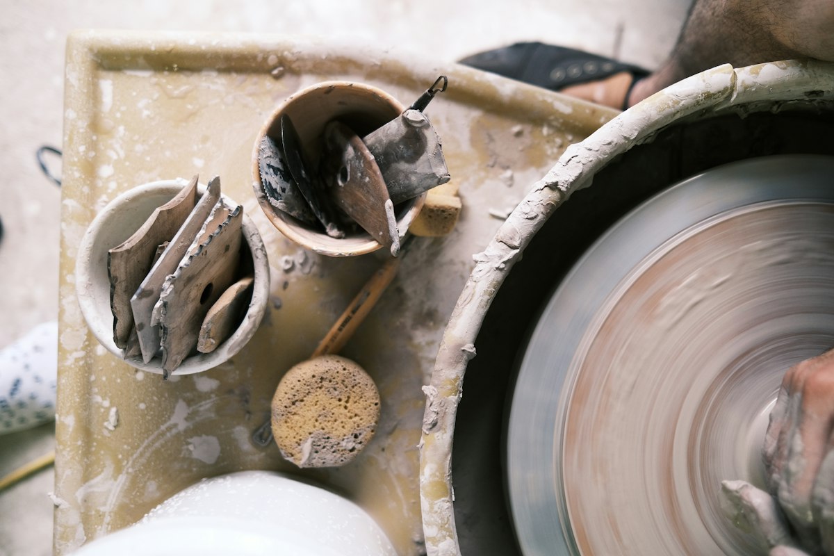 Maker shaping clay by hand, representing a brand story