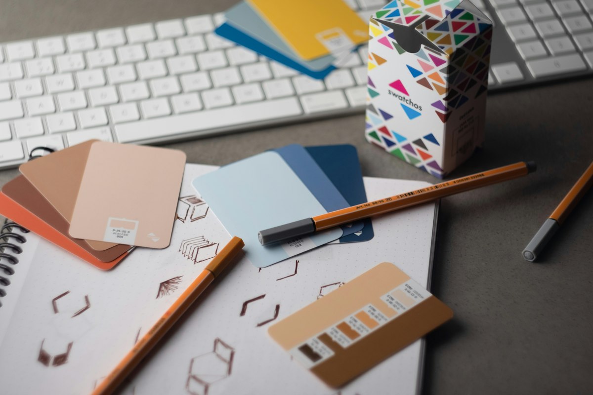 Designer workspace with keyboard and sketches