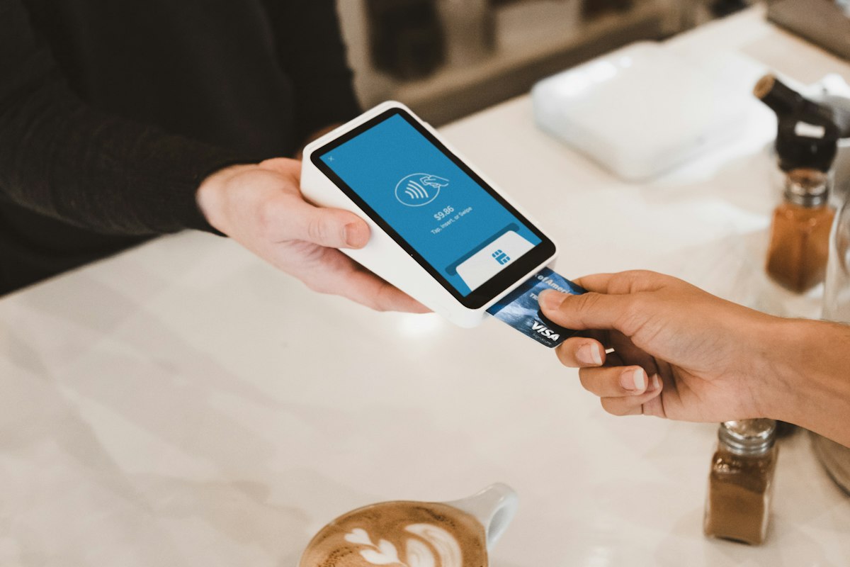 Card being inserted into a payment terminal for a merchant account
